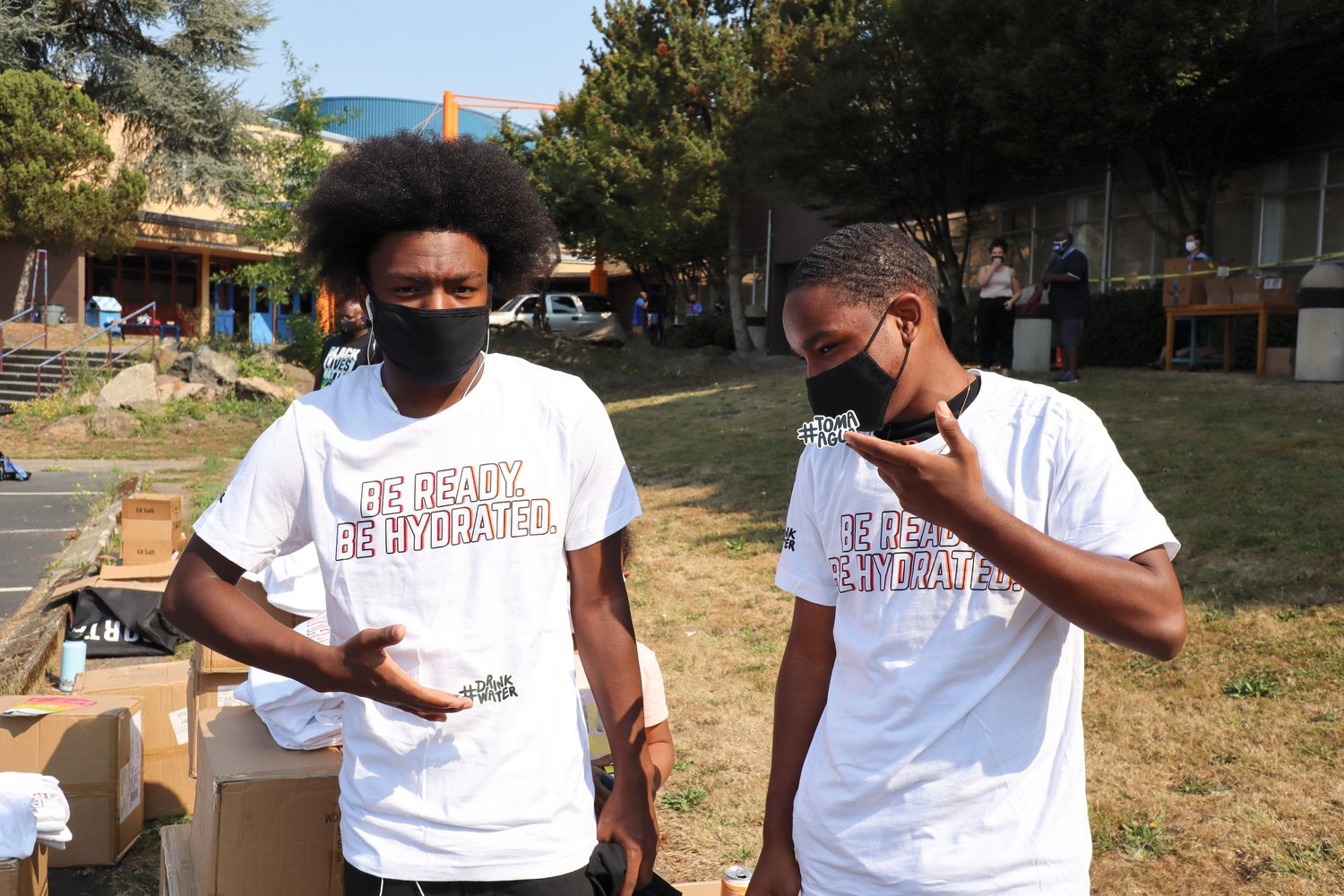 Two young people wearing Be Ready. Be Hydrated. campaign shirts at a Seattle community event