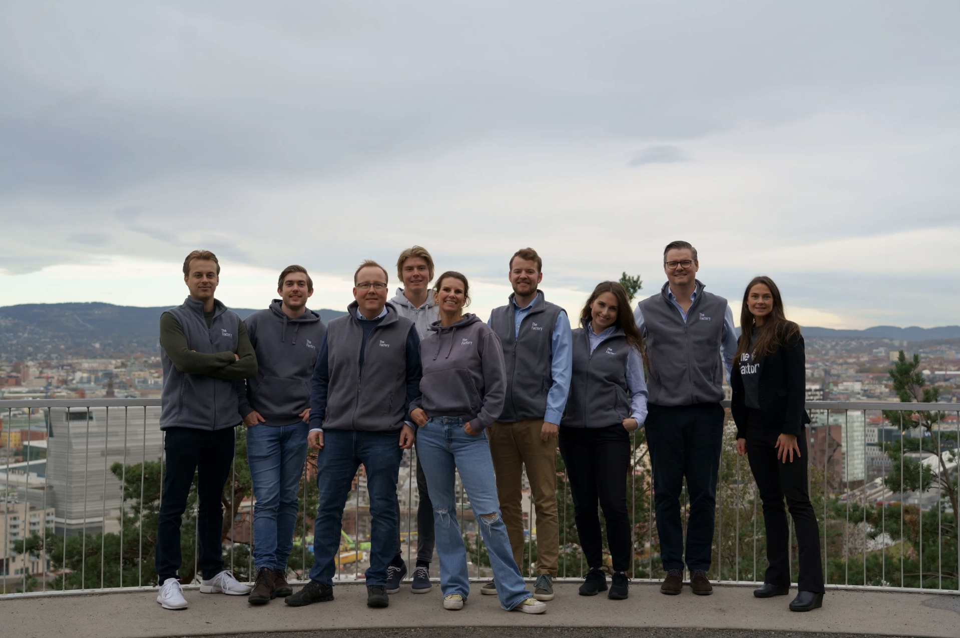 TheFactory team posing outdoors overlooking the city