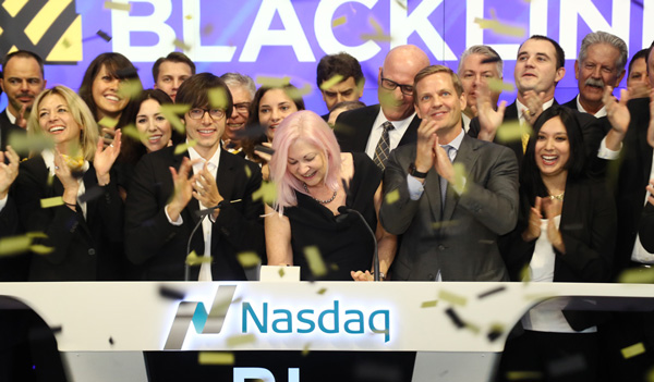 Therese Tucker and the BlackLine team celebrating at the Nasdaq opening bell amid yellow confetti