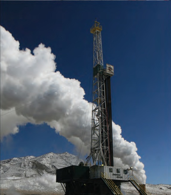 A ThermaSource drilling rig with steam rising against a blue sky and mountain backdrop