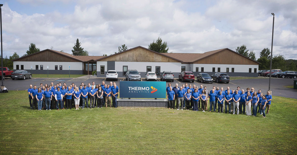 ThermoAnalytics employees gathered outside the company's Calumet, Michigan headquarters