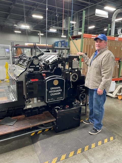 Think Patented operator Shawn beside an Original HEIDELBERG Cylinder press