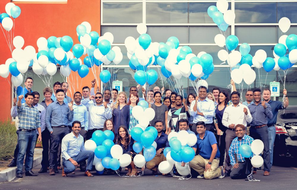 MST colleagues gathered outside with blue and white balloons