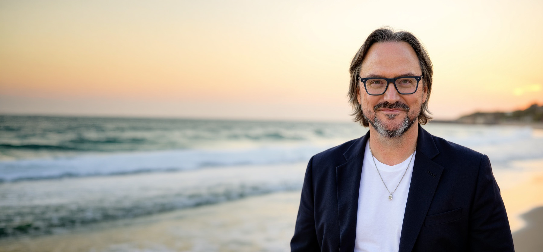 Robert Rose wearing glasses beside the ocean