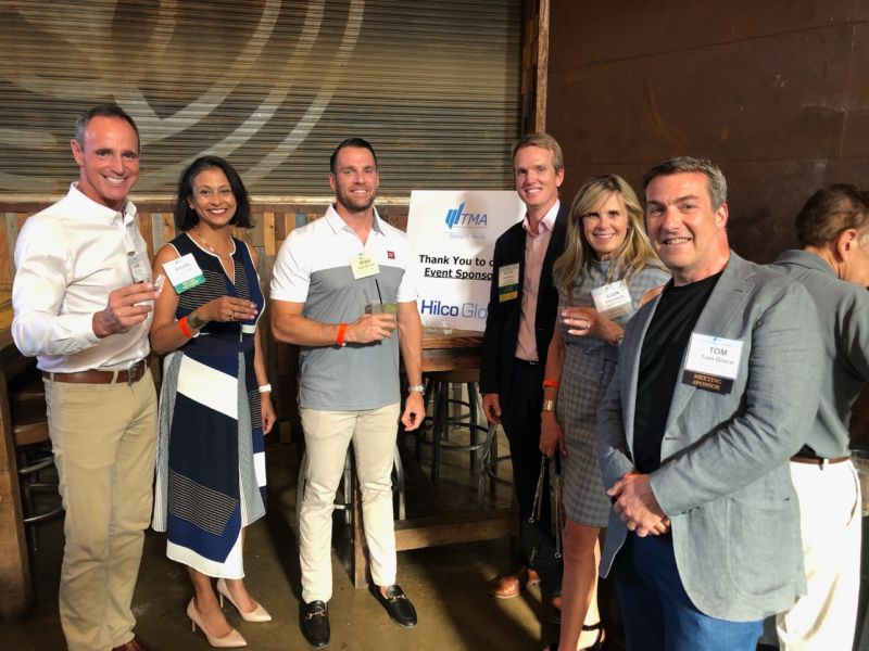 Thomas Greco, at right in a grey jacket, with attendees at the Hilco-sponsored TMA DFW summer wine tasting.