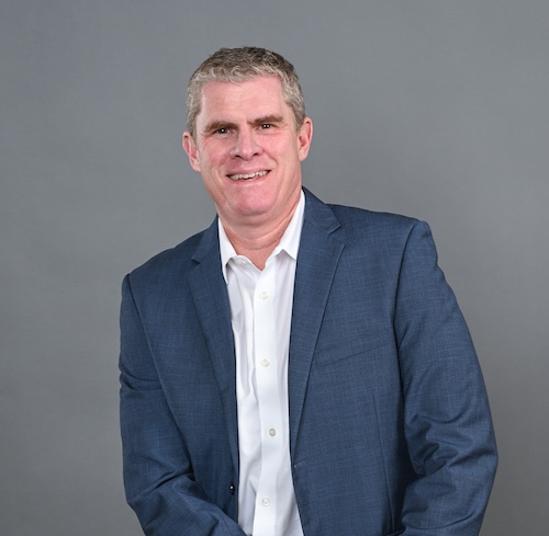 Thomas Lake in a dark jacket and pale blue shirt