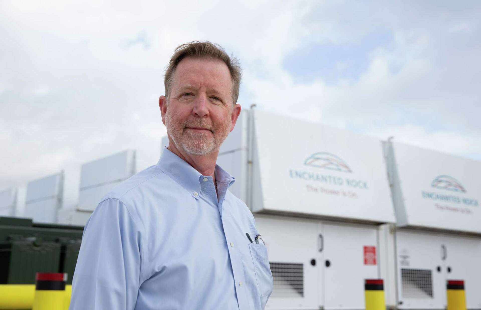 Thomas McAndrew beside Enchanted Rock generators at Fort Bend Levee Improvement District No. 2 in Sugar Land