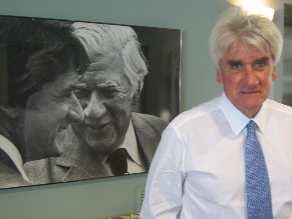 Tom O’Neill beside a portrait showing himself with his father, Tip O’Neill