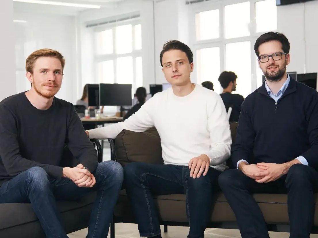 Trade Republic co-founders Marco Cancellieri, Christian Hecker and Thomas Pischke seated together in their office