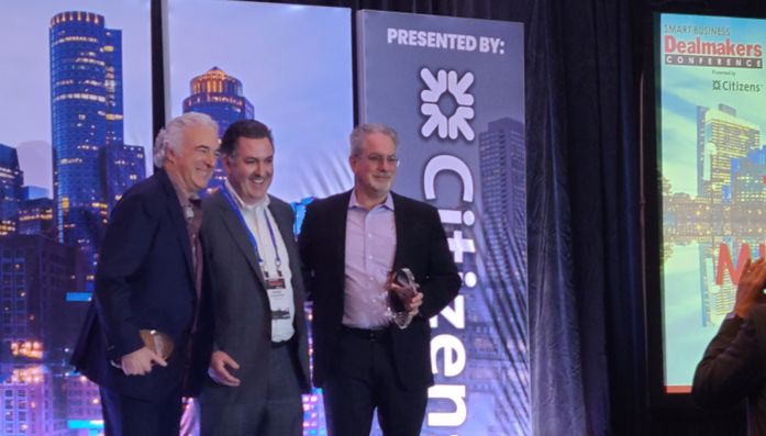 Thomas Pullen with hospitality technology colleagues on an event stage