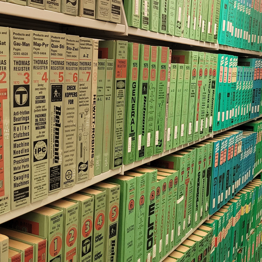 A shelf of vintage green Thomas Register industrial directories at the Library of Virginia