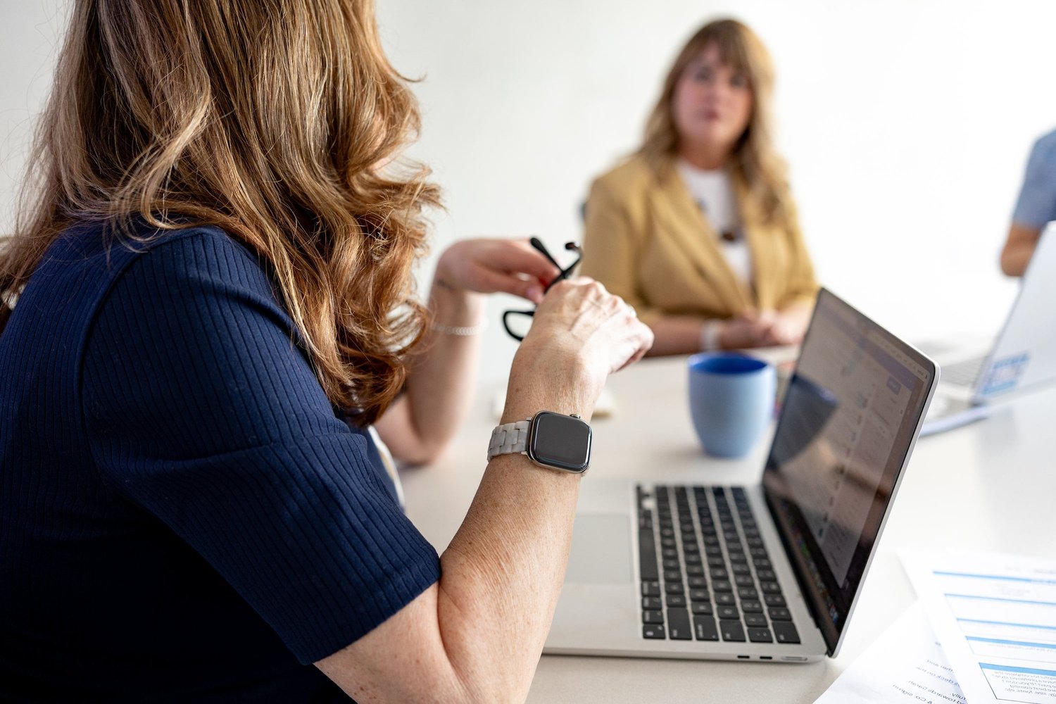 Thompson & Co. colleagues in a meeting around a laptop