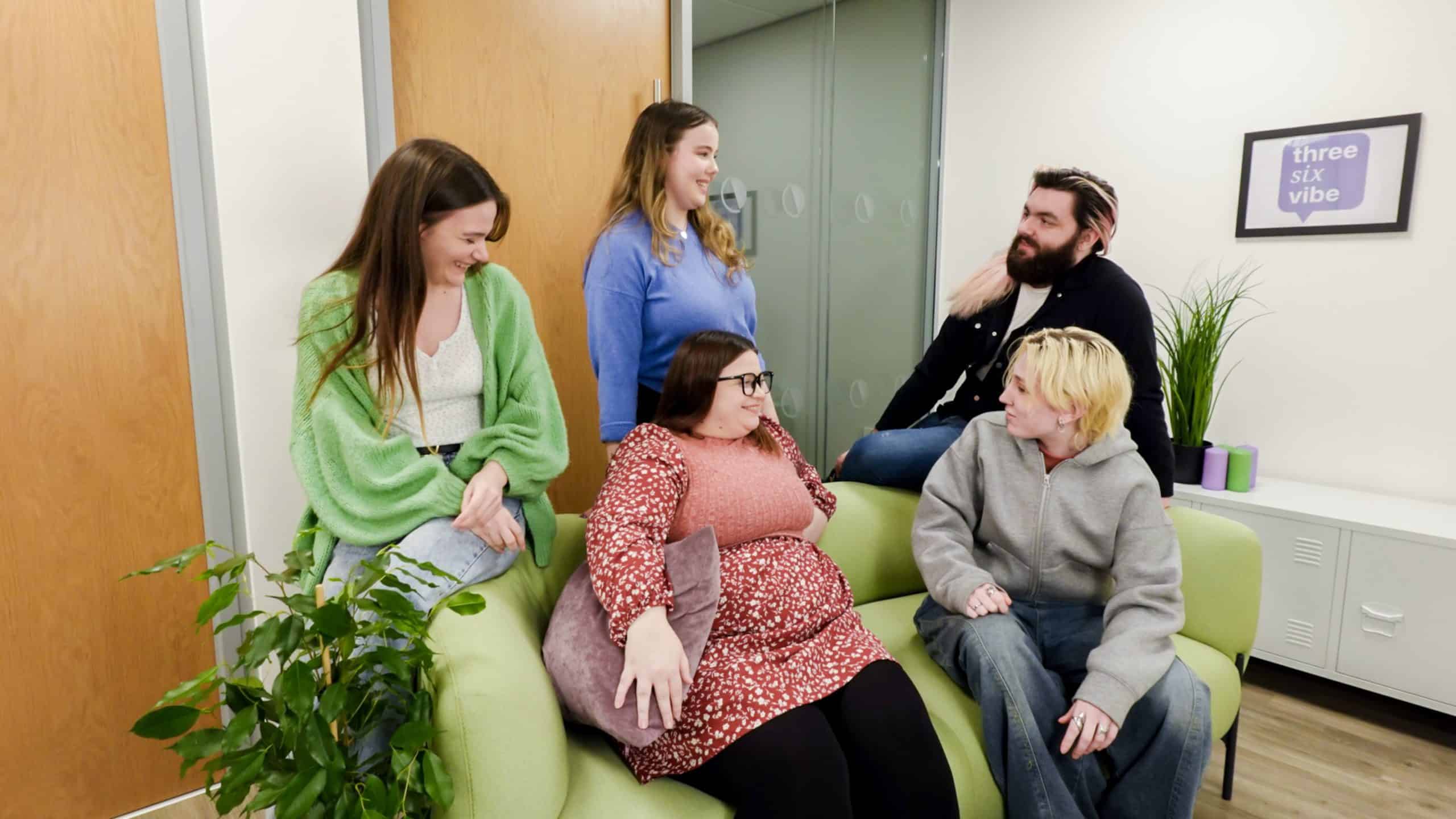 Members of the threesixfive team talking together in their North Devon office