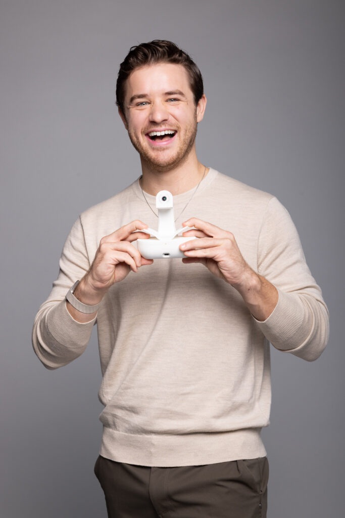 Throne CEO Scott Hickle holding the toilet-mounted sensor