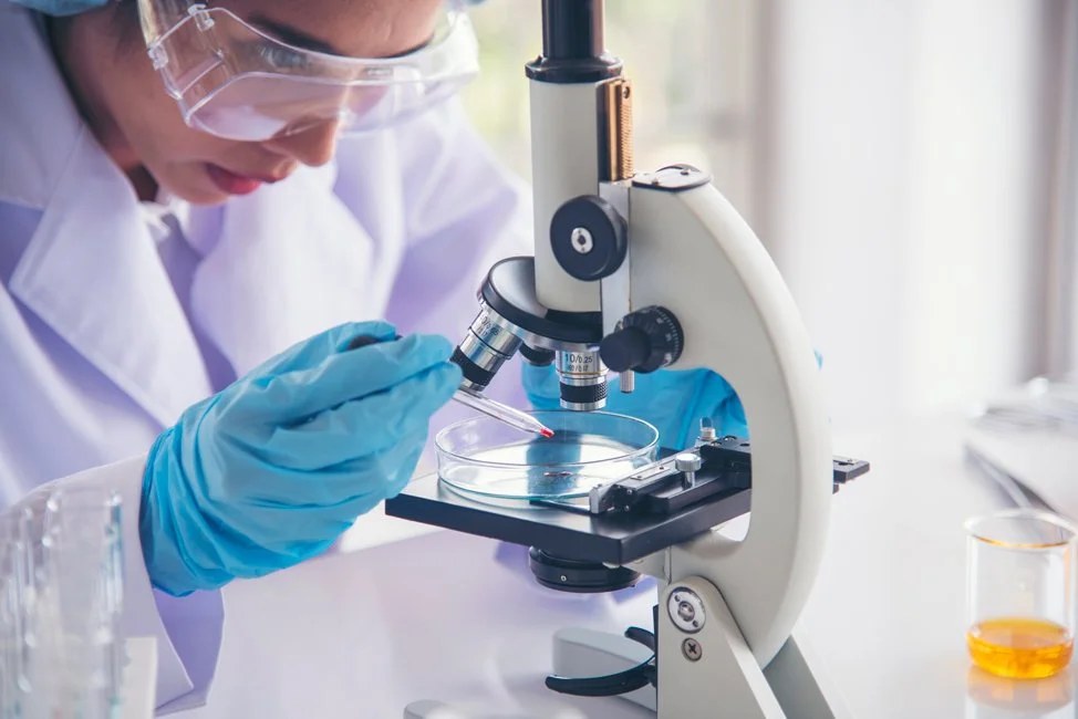 Scientist at a microscope in the lab