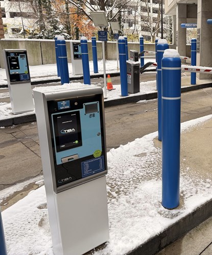 Close view of TIBA lane terminals and barrier gates in winter at Marconi Garage