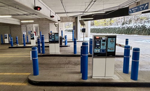 TIBA payment and exit equipment between blue bollards at Marconi Garage in Columbus