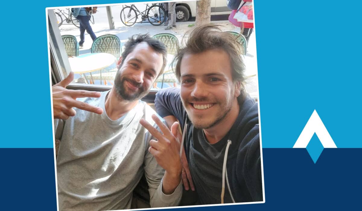 Tom Jacquesson at left and Tibo Louis-Lucas at right smile together at a cafe