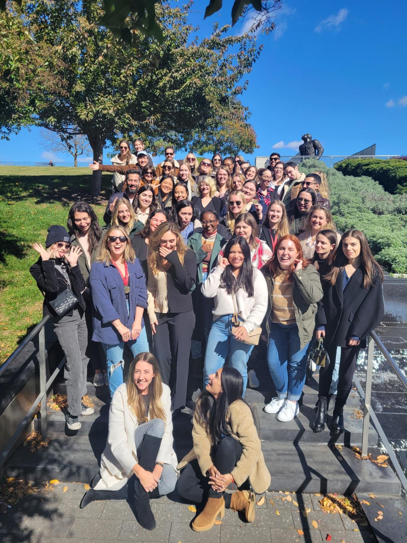 UpSpring colleagues gathered outdoors on steps during a team retreat in Richmond, Virginia