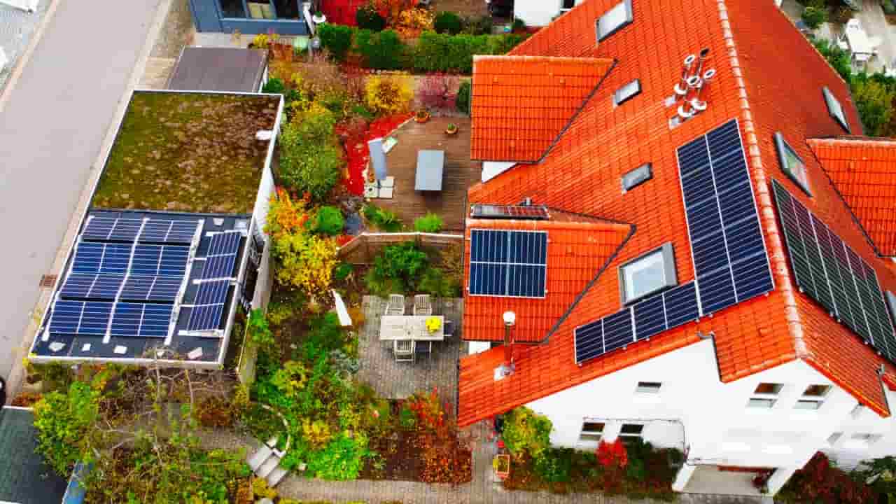 Aerial view of solar panels arranged across several sections of a residential roof