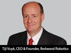 Tijl Vuyk wearing a suit and red tie in a Redwood Robotics press portrait