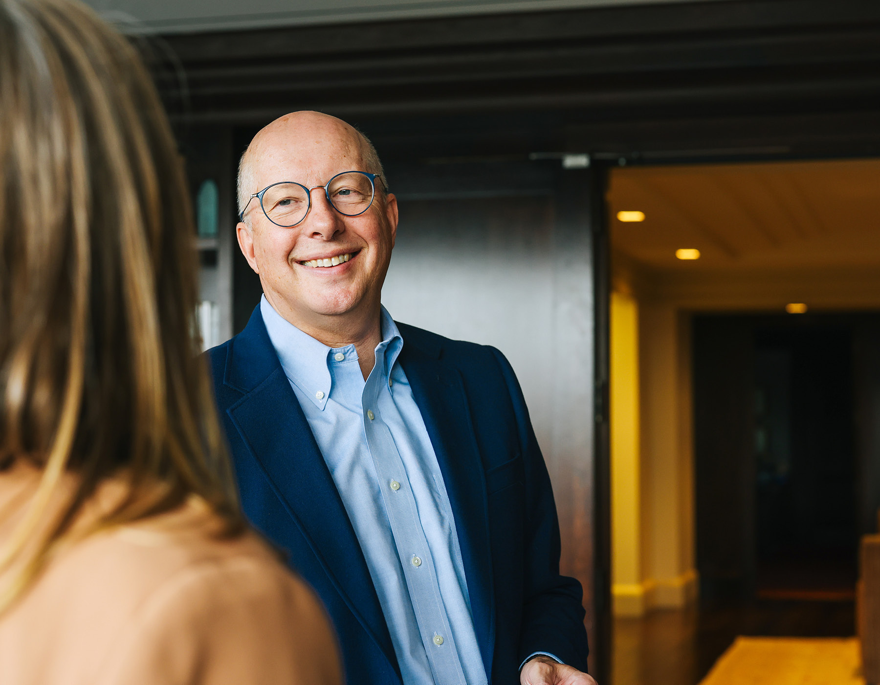 Tim Crane smiling while speaking with another person