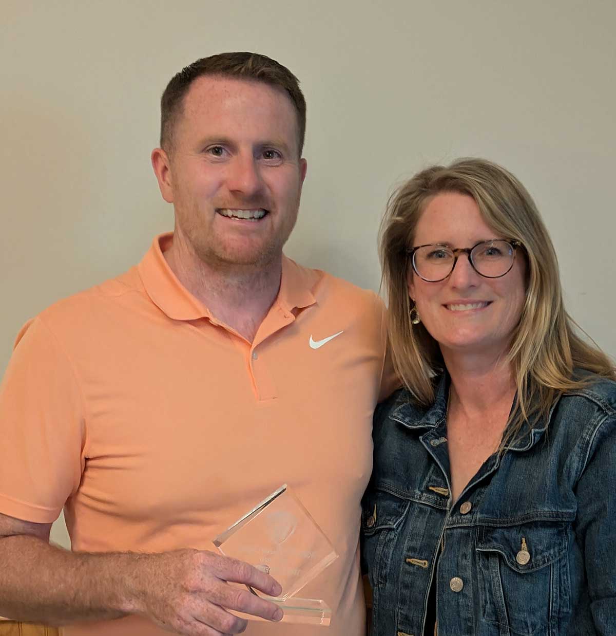 Tim Fitzgerald, left, receiving the Wakefield Soccer Association Presidential Legacy Award beside Ashley Renzi