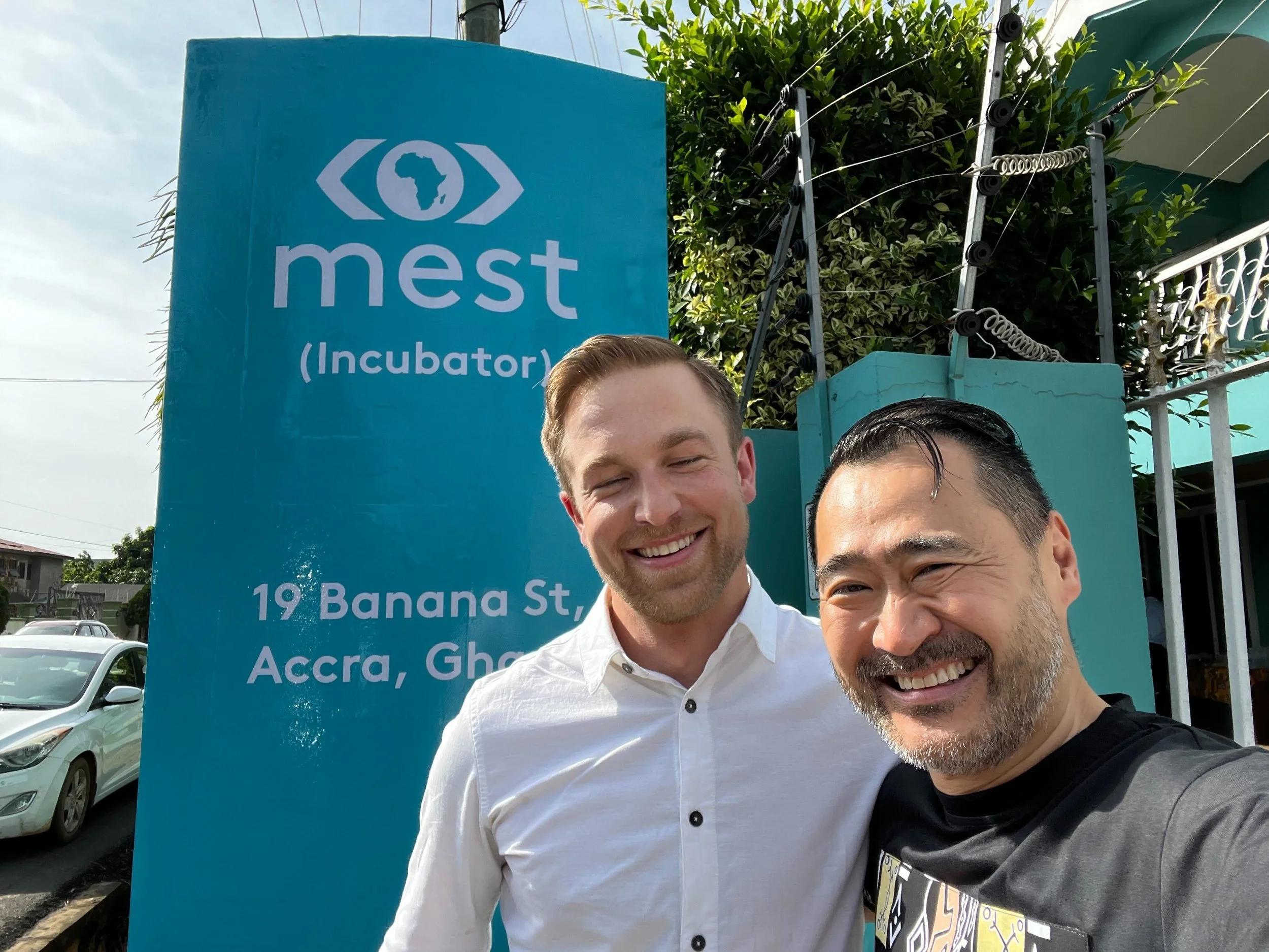 Tim Harsch, left, outside the MEST incubator in Accra with another visitor