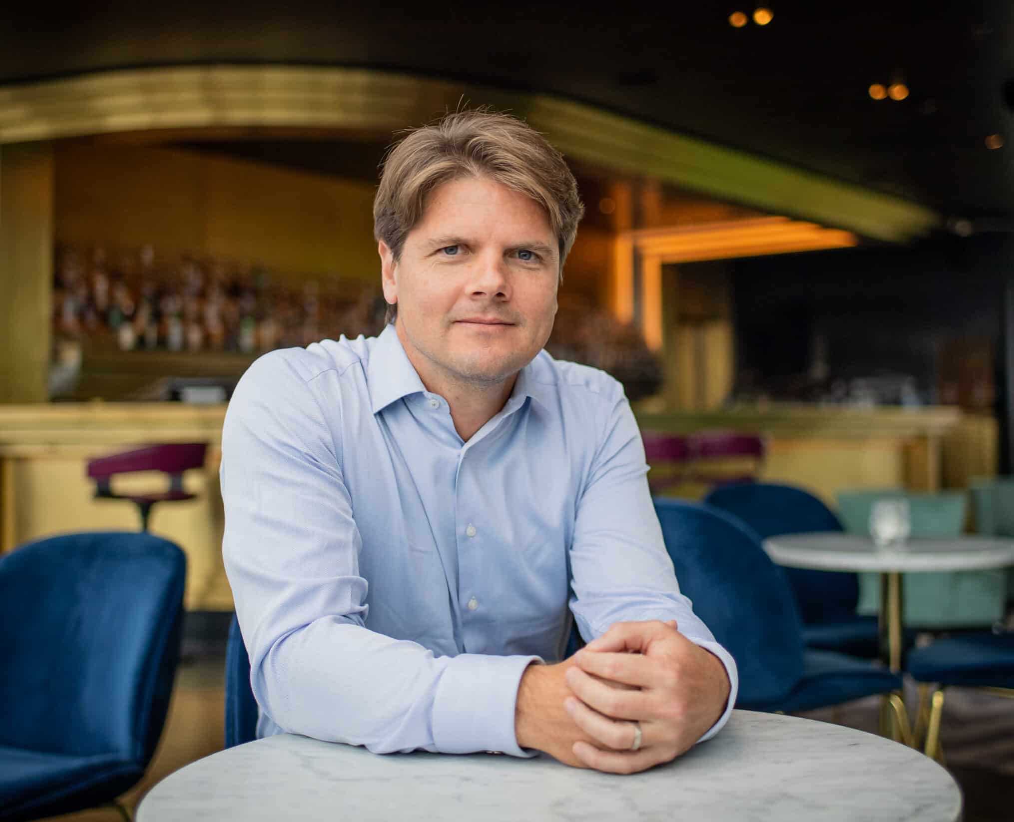 Tim Hentschel seated at a table in a hotel lounge