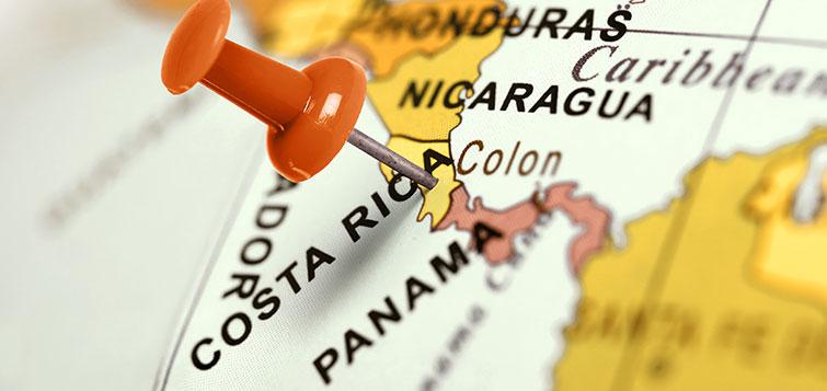 An orange pushpin marks Costa Rica on a map
