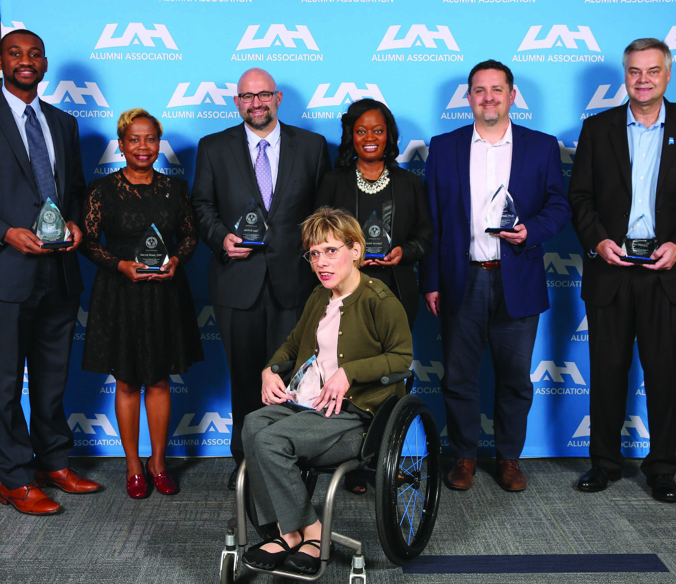 The 2019 UAH alumni award recipients pose together holding their awards, with Tim Thornton at the far right.