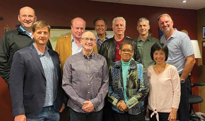 Strategic Renewal board members gathered indoors; Tim Tyannikov stands at the front left.
