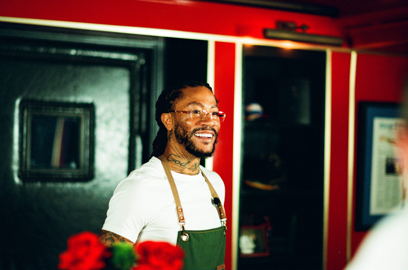 Derrick Rose smiling in an apron at the Chicago flower-shop activation