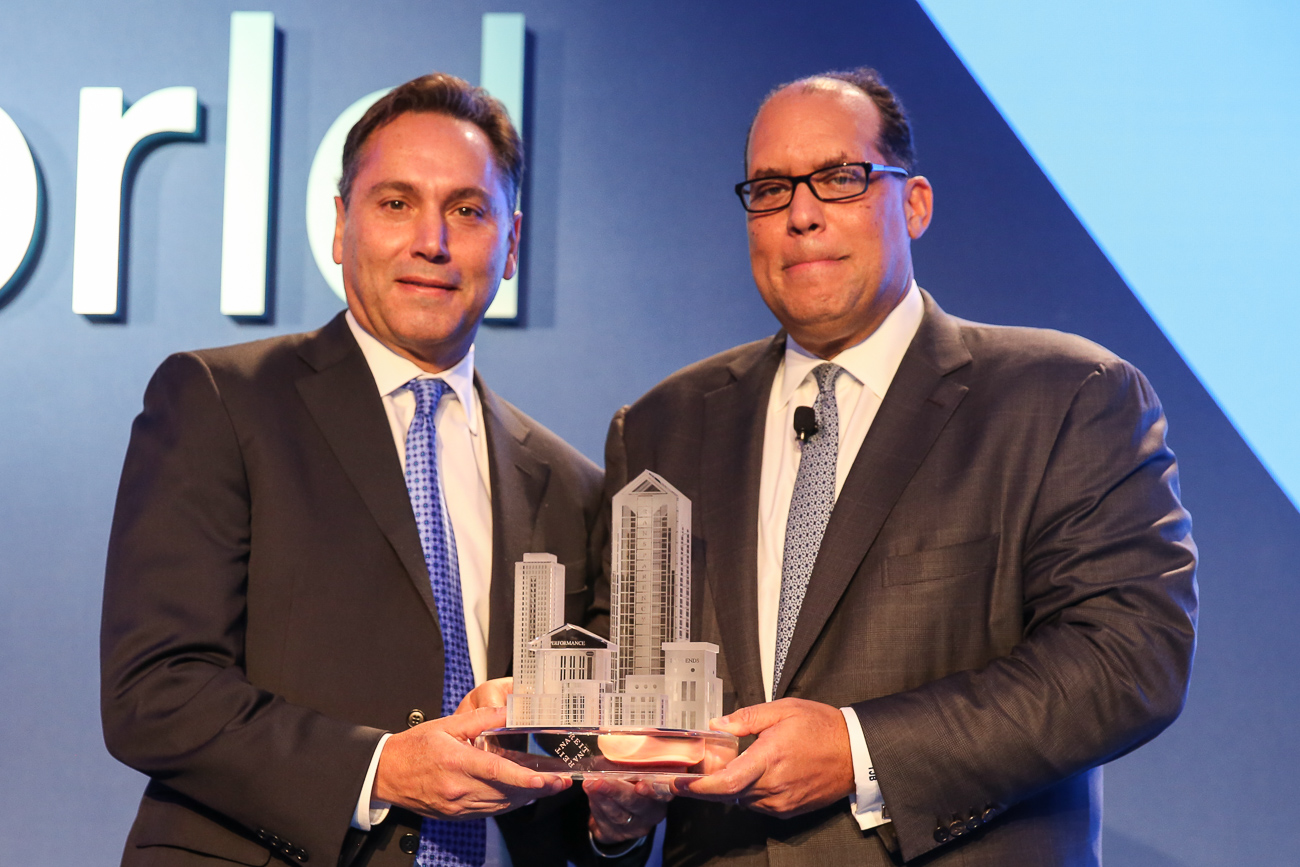 Tim Naughton, left, and Thomas Baltimore holding an architectural trophy at REITworld 2017