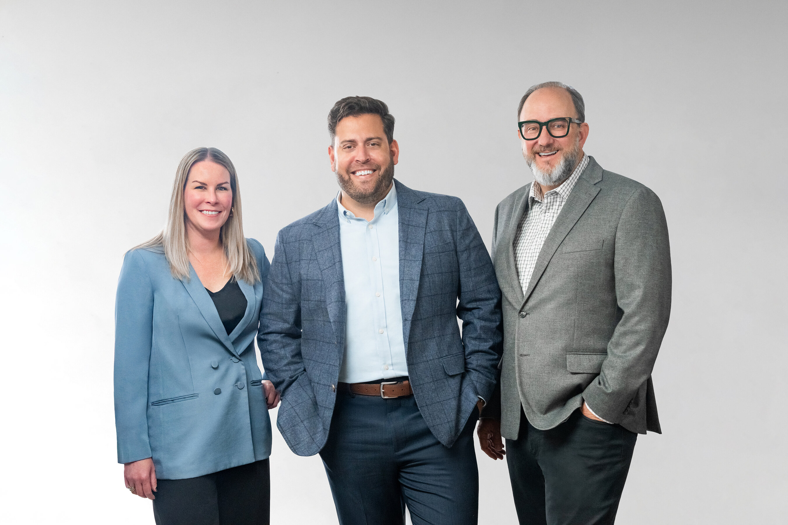 Tiny Mighty Communications leaders Brittnei Krafzig, Eric Tieles and Paul Oakley standing together