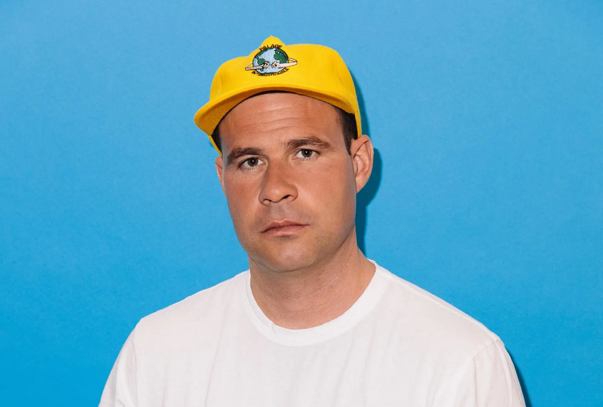 Tiptop co-founder Bastian Lehmann wearing a yellow cap against a blue background