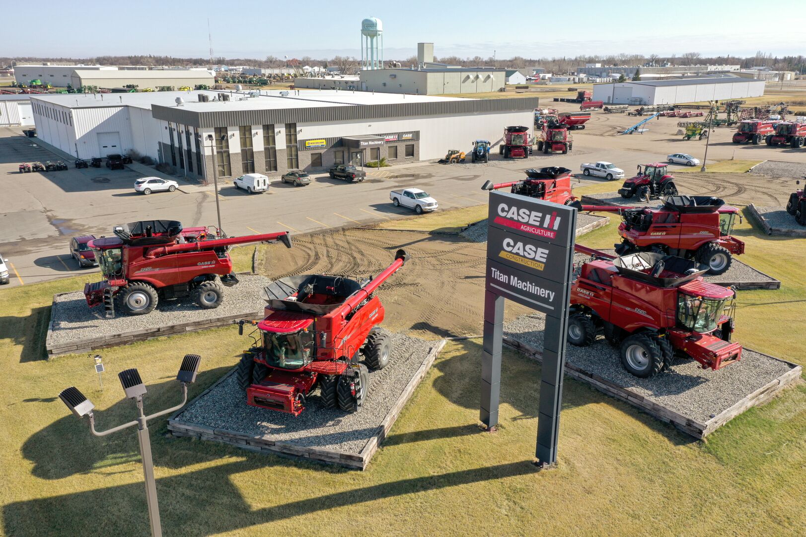 Aerial view of a Titan Machinery dealership with red Case IH combines arranged outside