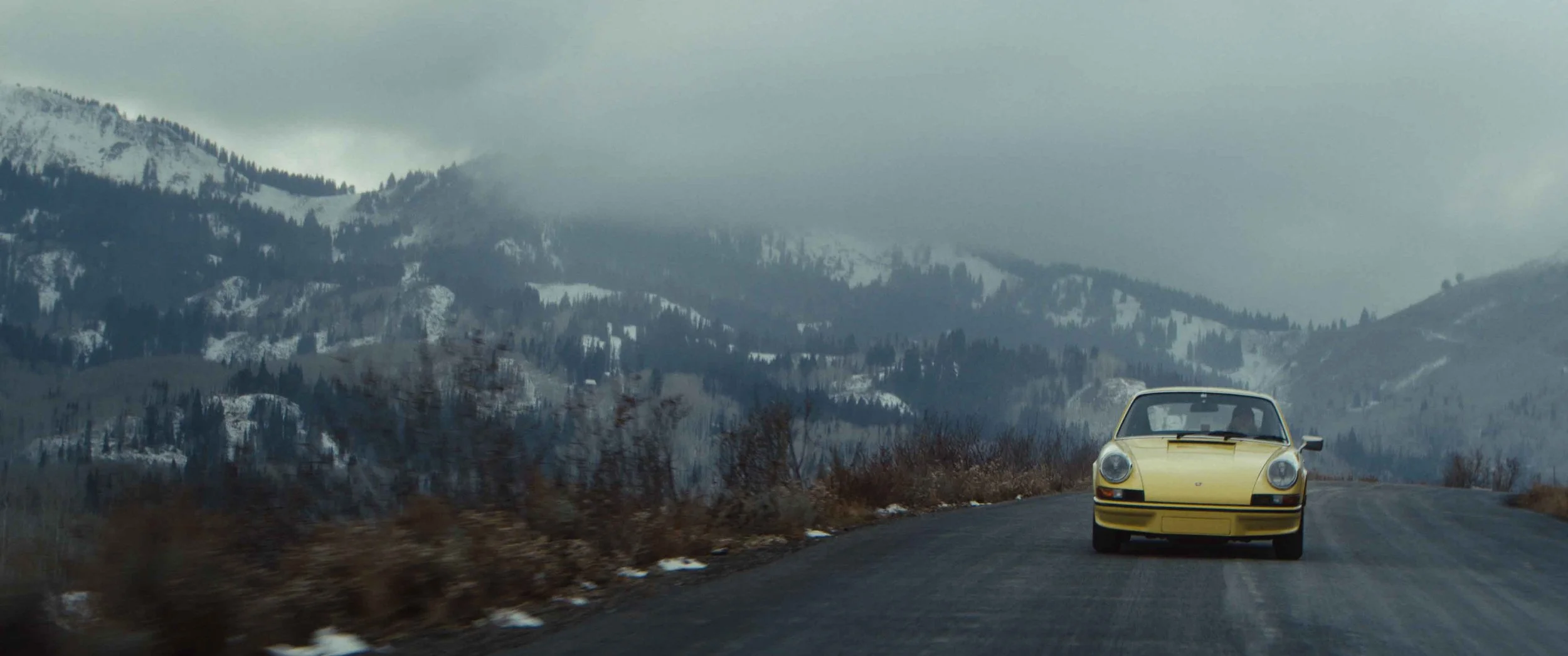 TJ Parker's yellow Porsche on a mountain road near Park City