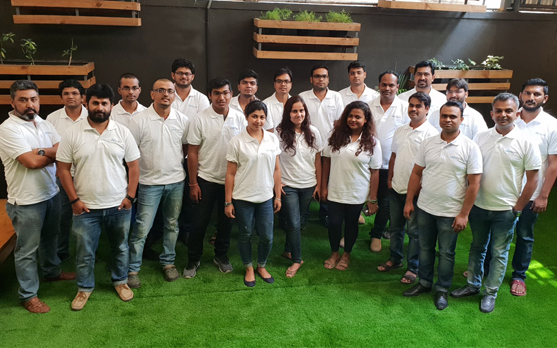 An early Lifesight team gathers for a group photograph in white company polo shirts.