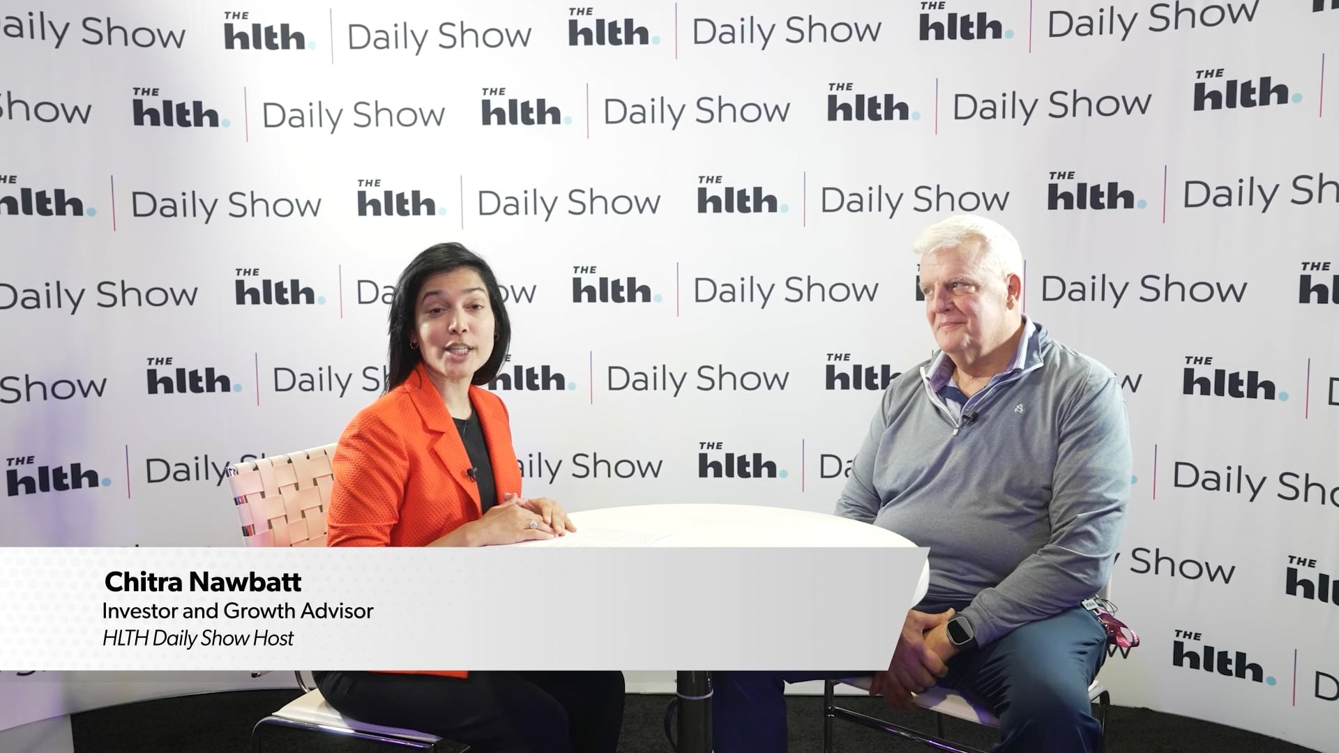 Chitra Nawbatt interviewing Todd Cozzens, seated on the right, on the HLTH Daily Show