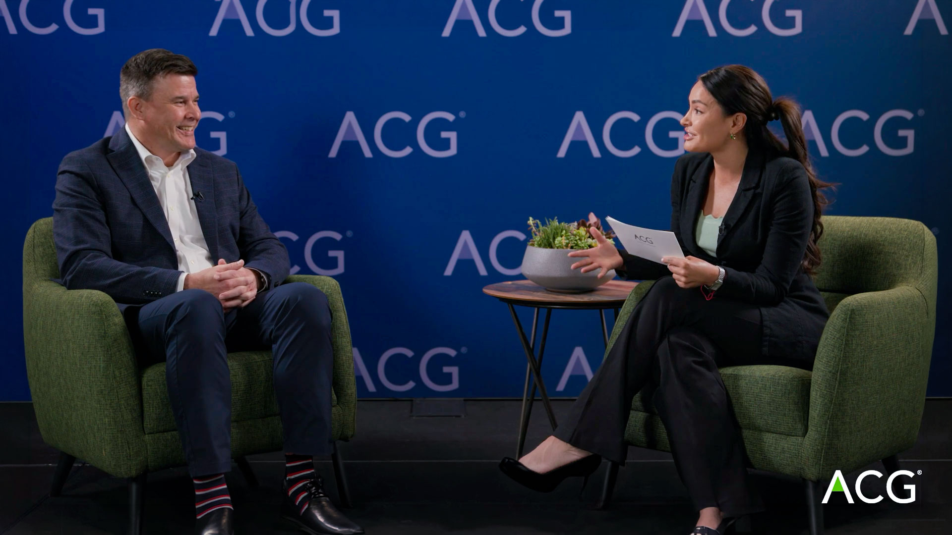 Todd Partridge in conversation with an interviewer on the ACG stage at DealMAX 2026