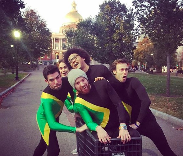 A playful group photograph shared with Tom Coburn’s 2018 interview, showing four friends in costumes around a shopping cart.