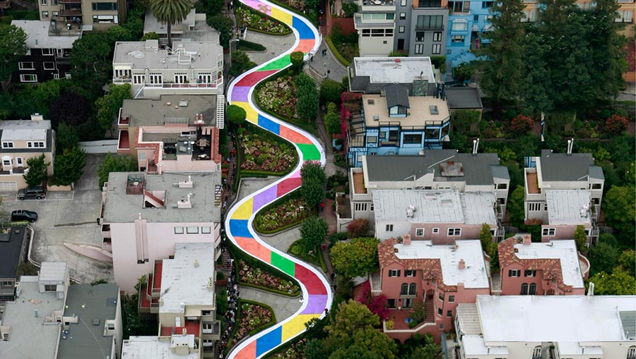 Lombard Street covered with colored Candy Land game squares, with spectators along the street