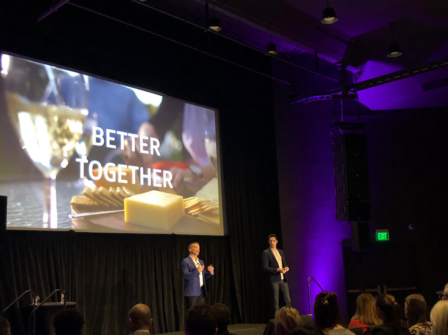 Tom Gerace, left, and Allen Gannett speaking onstage beneath a Better Together presentation at Forward 2019
