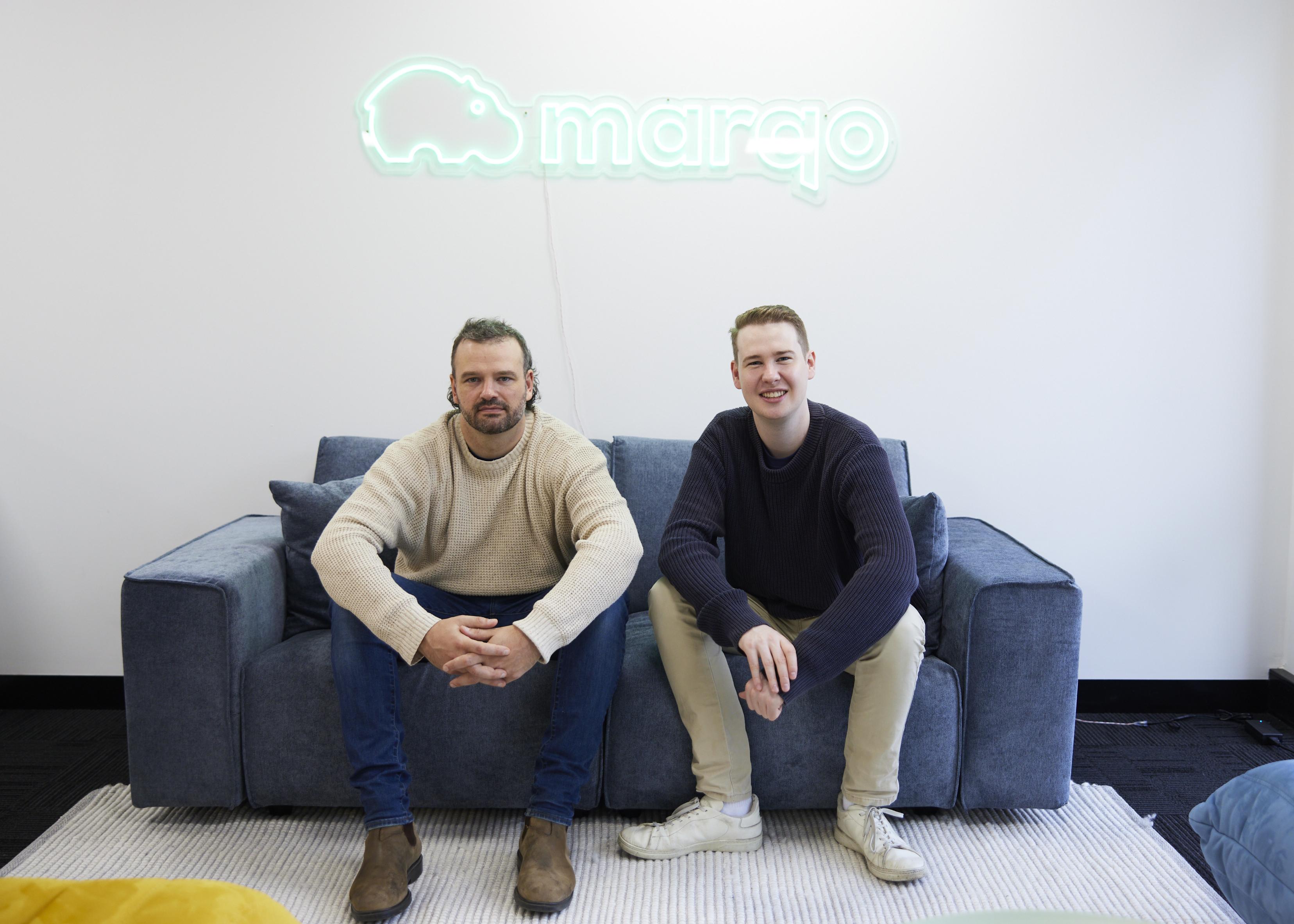 Jesse Clark and Tom Hamer seated together beneath a Marqo sign