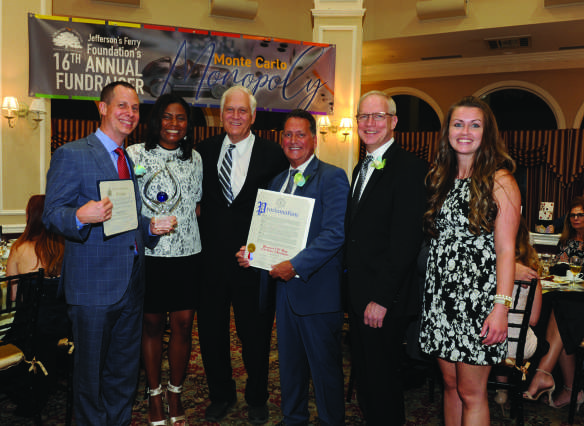 Tom Hyde, at left holding a plaque, with fellow attendees at the 2019 Jefferson’s Ferry Monte Carlo fundraiser