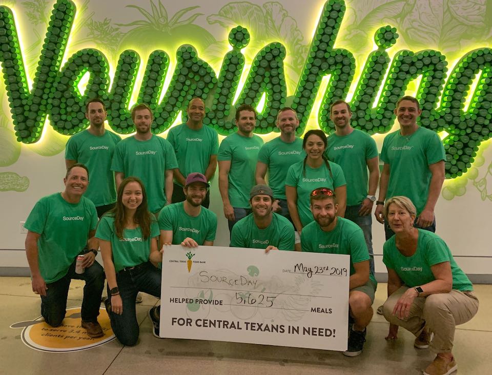 SourceDay volunteers at the Central Texas Food Bank holding a sign recording 5,625 meals, dated May 23, 2019
