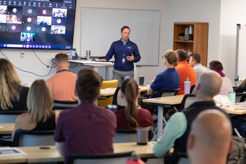 Tom King presents Skyward's go-to-market strategy to employees in a classroom