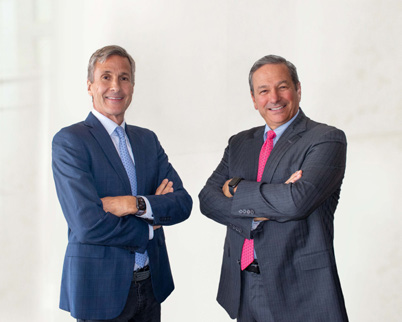 Tom Long, left, and Mackie McCrea standing together in suits
