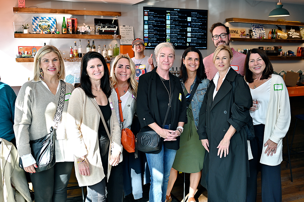 Tom Makinney, standing toward the right, with fellow real estate professionals at Beer on the Wall in Elmhurst.
